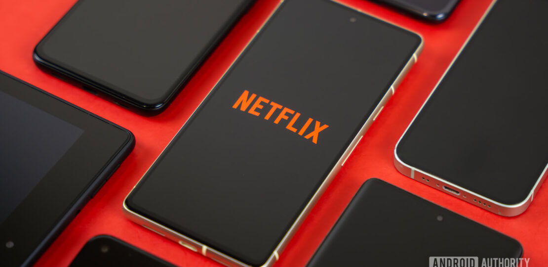 Netflix-logo-on-smartphone-next-to-other-devices-stock-photo-3.jpg
