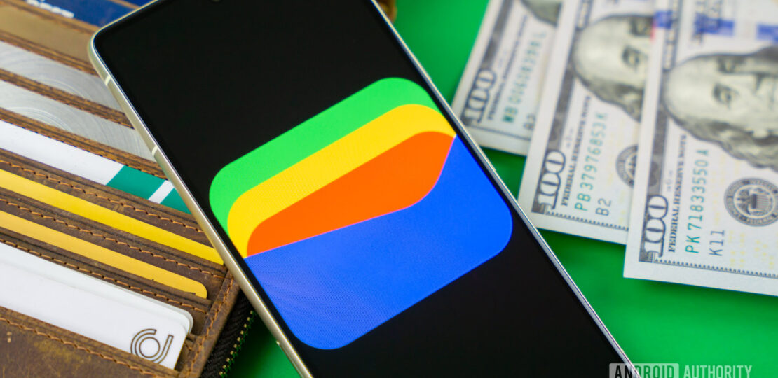 Google-Wallet-logo-on-smartphone-next-to-credit-cards-and-cash-Stock-photo-11.jpg